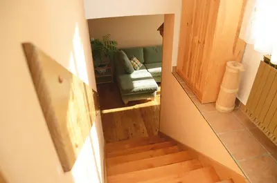 a view of a living room with a couch and stairs at Tourist Farm Žvanč in Kobarid
