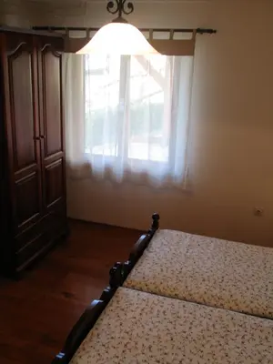 a bedroom with a bed and a window at Tourist Farm Žvanč in Kobarid