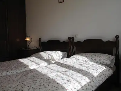 a bedroom with a bed with a comforter on it at Tourist Farm Žvanč in Kobarid