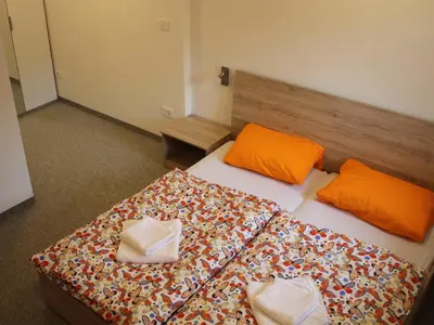 a room with two beds with orange pillows at Apartment Pri nama in Bovec