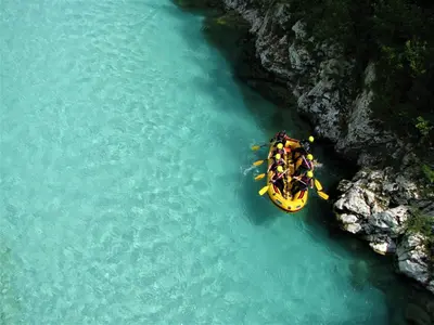 a group of people in a yellow boat on a river at Apartment Pri nama in Bovec