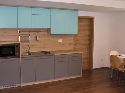 a kitchen with a sink and blue cabinets at Apartment Pri nama in Bovec
