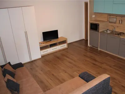 a living room with a couch and a flat screen tv at Apartment Pri nama in Bovec