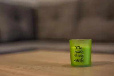 a green cup with the words my home is my asset at Podkoren Apartments in Kranjska Gora