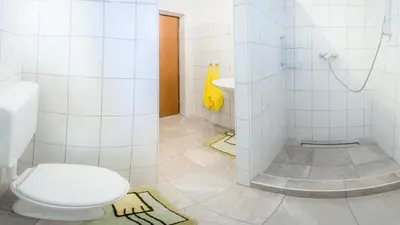 a bathroom with a toilet and a sink at 1A Adventure Hostel in Lesce