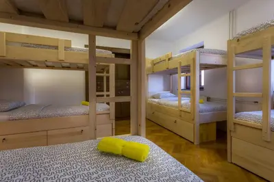 a bedroom with four bunk beds in a room at 1A Adventure Hostel in Lesce