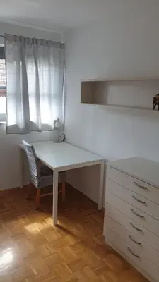 a white desk and a chair in a room at Apartment EMMA Ljubljana - FREE parking, AC, Wifi in Ljubljana