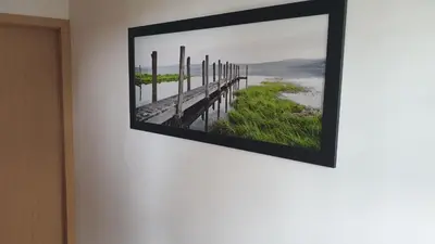 a framed picture of a pier on a wall at Apartment EMMA Ljubljana - FREE parking, AC, Wifi in Ljubljana