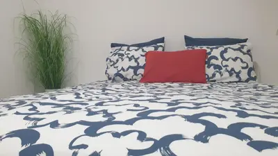 a bedroom with a bed with a red pillow at Apartment EMMA Ljubljana - FREE parking, AC, Wifi in Ljubljana