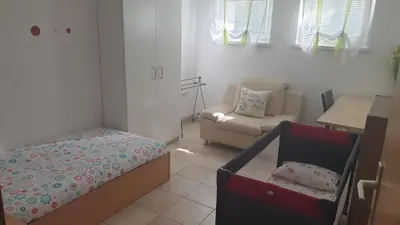 a bedroom with a bed and a couch in a room at Apartment EMMA Ljubljana - FREE parking, AC, Wifi in Ljubljana