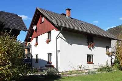 a white house with a red roof at Apartment Bernik II in Kranjska Gora
