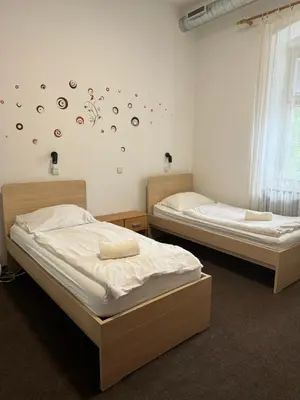 two twin beds in a room with planets on the wall at Guesthouse Pri Tonetu in Ptuj