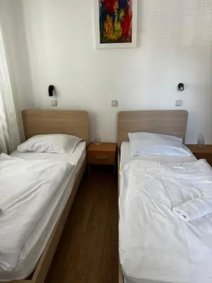 two beds sitting next to each other in a room at Guesthouse Pri Tonetu in Ptuj