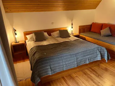 a bedroom with two beds and two lamps on tables at Govc-Vršnik in Solčava