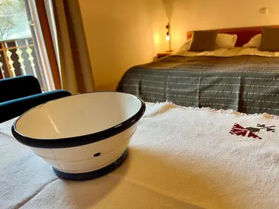 a black and white bowl sitting on a towel next to a bed at Govc-Vršnik in Solčava