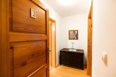 a room with a wooden door and a table at Govc-Vršnik in Solčava