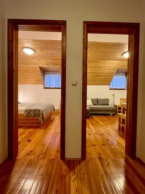 a room with a bedroom and a bed and a living room at Govc-Vršnik in Solčava