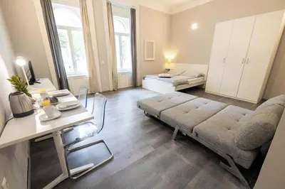 a living room with a couch and a bed at 4flats in Maribor