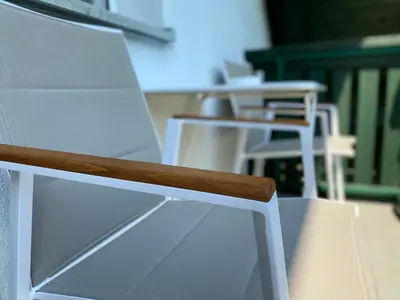 a row of white chairs sitting next to each other at Apartments Alpha Center in Bovec