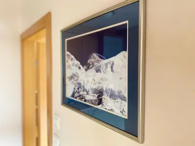 a picture of a mountain in a frame on a wall at Apartments Alpha Center in Bovec
