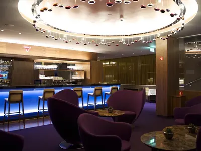 a bar in a restaurant with purple chairs and tables at Atlantida Boutique Hotel in Rogaška Slatina