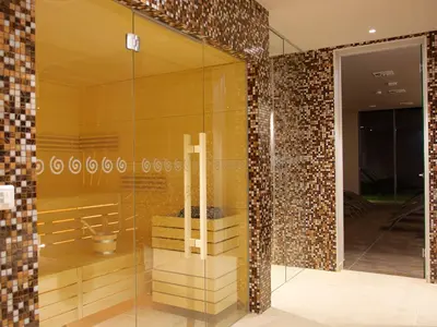a lobby with a glass wall with a bench in it at Atlantida Boutique Hotel in Rogaška Slatina