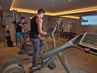 two men on a treadmill in a gym at Atlantida Boutique Hotel in Rogaška Slatina