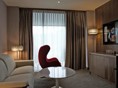 a living room with a couch and a chair and a table at Atlantida Boutique Hotel in Rogaška Slatina