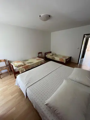 a bedroom with two beds and a window at Apartments Klabjan in Osp