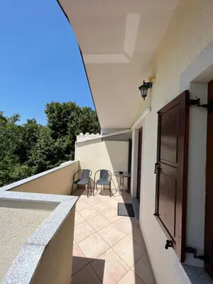 a balcony with two chairs and a table on it at Apartments Klabjan in Osp