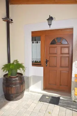 a wooden door with a potted plant in front of it at Apartments Klabjan in Osp