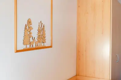 a picture of trees on a wall next to a door at Hotel House Rozka in Cerklje na Gorenjskem