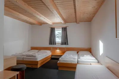 a bedroom with two beds and a window at Hotel House Rozka in Cerklje na Gorenjskem