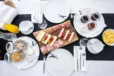a table with white plates and food on it at Škrabčeva domačija in Ribnica