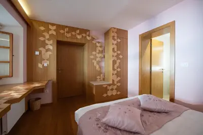 a bedroom with a bed and a desk in it at Škrabčeva domačija in Ribnica