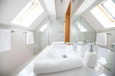 a white bathroom with a sink and a tub at Škrabčeva domačija in Ribnica