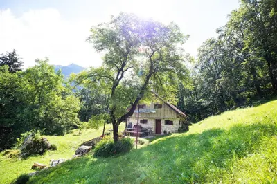 a small house on a hill in a field at Miha lodge - Mihčevo pleče in Soča