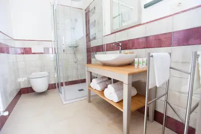 a bathroom with a sink and a shower at Casa Krasna Gourmet Boutique Hotel in Lokev