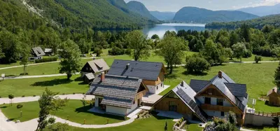an aerial view of a house with a lake at PRIVILLAGE Stare - Villa & Chalet in Bohinj