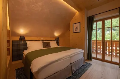 a bedroom with a bed and a large window at PRIVILLAGE Stare - Villa & Chalet in Bohinj