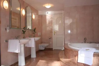a bathroom with two sinks and a tub and a toilet at PRIVILLAGE Stare - Villa & Chalet in Bohinj