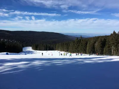 a group of people skiing on a snow covered slope at Apartment Gaber 82 in Zreče