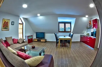 a living room with a couch and a table at Apartmaji Smogavc in Zreče