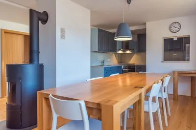 a kitchen with a wooden table and a stove at Villa Bohinca in Bohinj