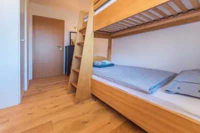 a bedroom with a bunk bed with a ladder at Villa Bohinca in Bohinj