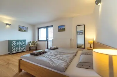 a bedroom with a large bed and a mirror at Villa Bohinca in Bohinj
