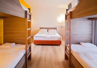 two bunk beds in a room with wooden floors at B&B HOTEL Maribor UNI Hostel in Maribor