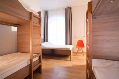 a bedroom with two bunk beds and a window at B&B HOTEL Maribor UNI Hostel in Maribor