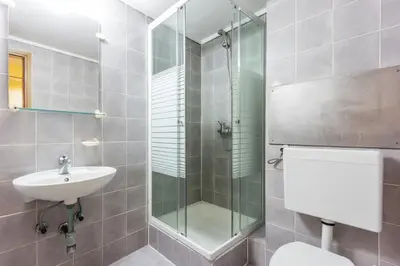 a bathroom with a shower and a toilet and a sink at B&B HOTEL Maribor UNI Hostel in Maribor