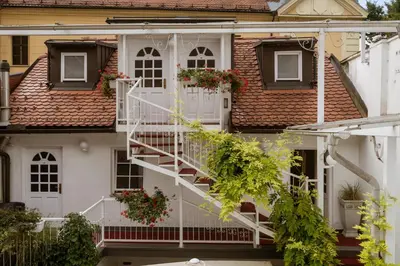 a white house with white stairs and windows at Allegro Hotel in Ljubljana